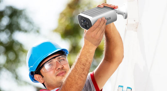 a worker is installing wireless security camera